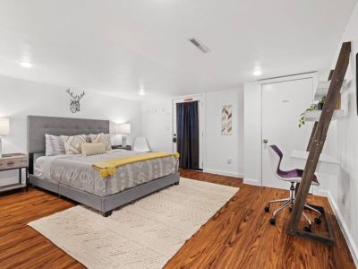 Venture downstairs to the spacious  basement where this large Queen bedroom awaits.