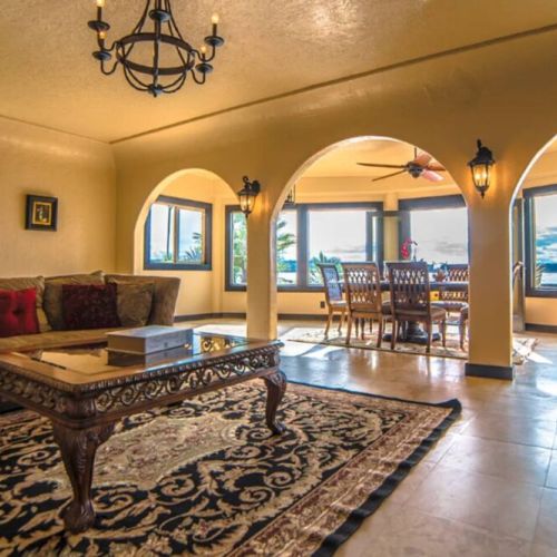 Sunlight pours in through floor-to-ceiling windows, showcasing a breathtaking view that seamlessly merges indoor comfort with the beauty of the outdoors.