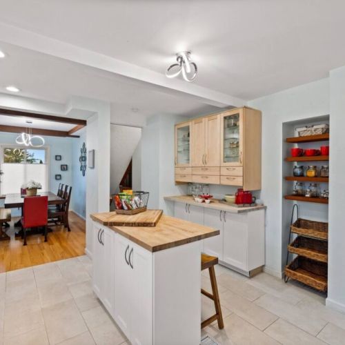 Gather with friends and family around the spacious kitchen island, complete with extra seating that ensures everyone has a place to enjoy culinary delights in this fully stocked kitchen.