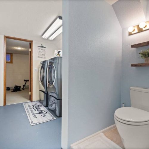 Discover the ultimate convenience in this lower-level laundry room with an attached bathroom for convenience, providing a seamless and efficient space for all your laundry needs