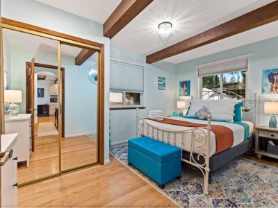 Settle in luxurious comfort in this spacious queen bedroom, conveniently located on the main floor for easy accessibility and convenience.