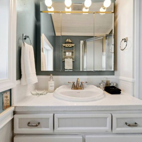 En suiter bathroom sink and linen closet.