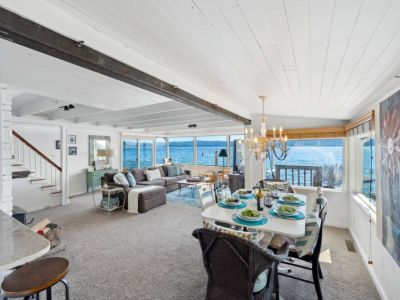 The open-concept design seamlessly connects the living room to the kitchen and dining area, making it an ideal space for entertaining guests or simply enjoying the serene ambiance with loved ones.