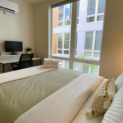 Tall windows provide natural light with full black out shades for privacy.