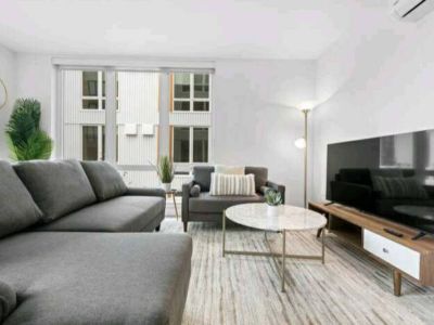 Positioned perfectly in the room, the TV becomes a portal to endless entertainment, casting a warm glow that transforms the space into a haven for cinematic experiences and cozy evenings.