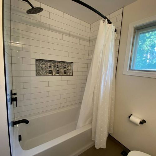 Newly Remodeled Main Bathroom Bathtub with Rain Head Shower