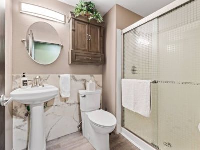Convenience meets style in this tastefully designed first-floor bathroom, located just across from the single bedroom. With its proximity to the single bedroom, this bathroom offers privacy and convenience