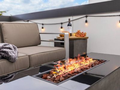 Relax with a warm blanket by the cozy firepit on the rooftop deck.