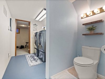 Discover the ultimate convenience in this lower-level laundry room with an attached bathroom for convenience, providing a seamless and efficient space for all your laundry needs