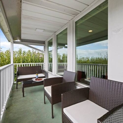 The living room/dining room private balcony is perfect for relaxing with a 4-burner gas grill for outdoor culinary adventures.