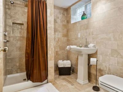 The bathroom on the lower-level features travertine floors with radiant heating.  This eco-friendly natural stone is a non-allergenic, making it suitable for individuals with allergies or respiratory sensitivities.