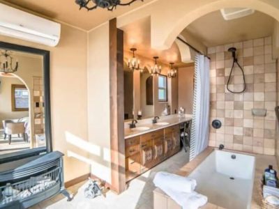 Soak in the deep elongated bathtub while being warmed by the ventless gas fireplace and taking in the water view from the King En Suite Bathroom