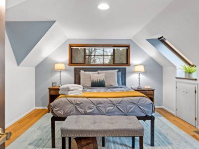 Discover a whimsical escape in this enchanting queen "treehouse" bedroom, adorned with skylights that fill the space with natural light. A dreamy haven that promises a truly magical experience.