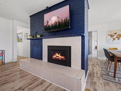 A mesmerizing gas fireplace takes center stage. Its sleek design and modern aesthetics seamlessly blend with the surrounding decor, creating an inviting and cozy atmosphere.