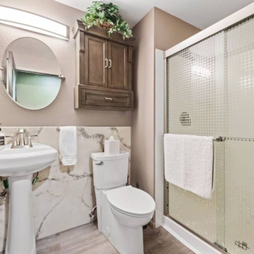Convenience meets style in this tastefully designed first-floor bathroom, located just across from the single bedroom. With its proximity to the single bedroom, this bathroom offers privacy and convenience