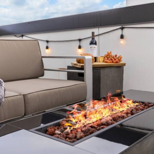 Relax with a warm blanket by the cozy firepit on the rooftop deck.