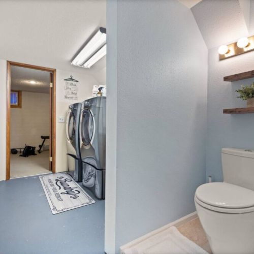 Discover the ultimate convenience in this lower-level laundry room with an attached bathroom for convenience, providing a seamless and efficient space for all your laundry needs