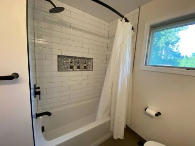 Newly Remodeled Main Bathroom Bathtub with Rain Head Shower