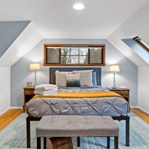 Discover a whimsical escape in this enchanting queen "treehouse" bedroom, adorned with skylights that fill the space with natural light. A dreamy haven that promises a truly magical experience.