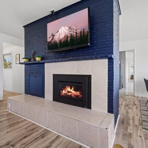 A mesmerizing gas fireplace takes center stage. Its sleek design and modern aesthetics seamlessly blend with the surrounding decor, creating an inviting and cozy atmosphere.