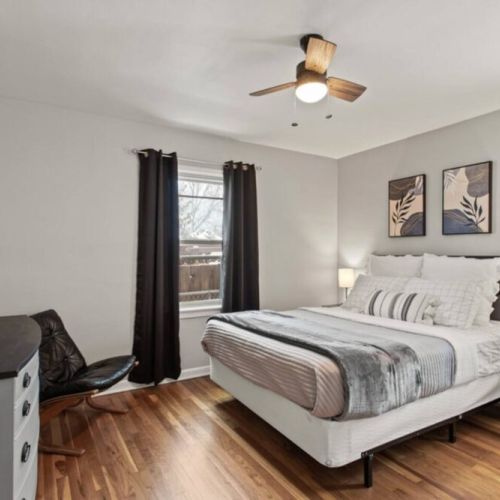 The spacious main floor queen bedroom  has  a three drawer dresser and black out curtains to ensure a good night’s sleep.