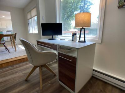 Working from home is easy with the full desk, upholstered swivel chair, and computer monitor.