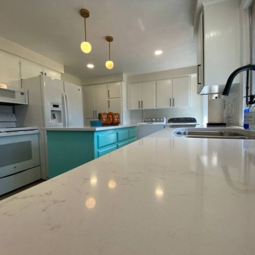Newly remodeled Kitchen (2024) with quartz countertops, deep double stainless sink, and kitchen island.
