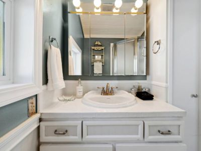 En suiter bathroom sink and linen closet.