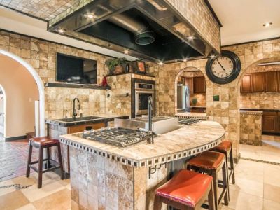 The Chef Kitchen's large island boasts 8 gas burners, a convenient pot filler, and indoor grill with gleaming countertops to an array of top-of-the-line appliances.