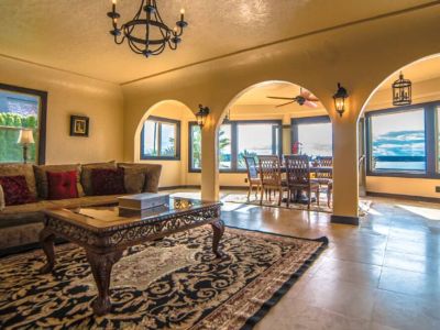 Sunlight pours in through floor-to-ceiling windows, showcasing a breathtaking view that seamlessly merges indoor comfort with the beauty of the outdoors.