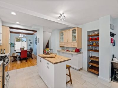 Gather with friends and family around the spacious kitchen island, complete with extra seating that ensures everyone has a place to enjoy culinary delights in this fully stocked kitchen.
