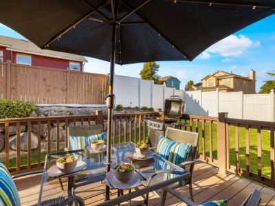 Step outside and immerse yourself in the inviting outdoor space of this deck, complete with comfortable tables and chairs.