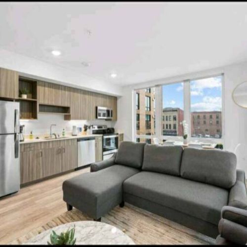 Cozy open concept living space with living, dining, and kitchen.