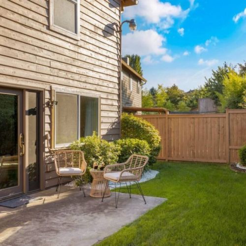 Relax, unwind, and savor the beauty of nature as you gather around this lovely coffee table with loved ones, creating lasting memories in the comfort of this backyard.