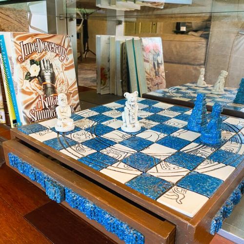 The lighted bookcase has several books and games to choose from.