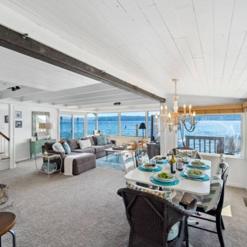 The open-concept design seamlessly connects the living room to the kitchen and dining area, making it an ideal space for entertaining guests or simply enjoying the serene ambiance with loved ones.