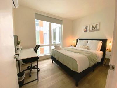 Front queen bedroom with office desk and monitor. A quiet room to work.