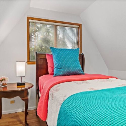 Cozy twin bed is nestled in the Treehouse Loft-snuggle in for a quiet night of rest.