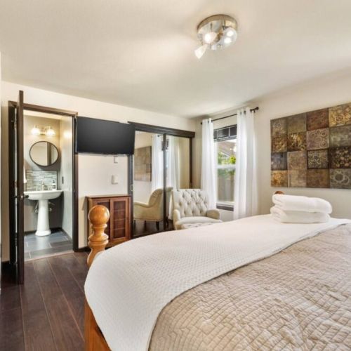 Indulge in the ultimate comfort and convenience in this en suite king bedroom, featuring a 42" smart TV, spacious double closet with a Graco Pack n Play. Take a much deserved break in the chair with ottoman.