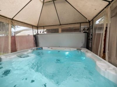 The hot tub is nestled under a canopy for extra privacy as you enjoy the soak.
