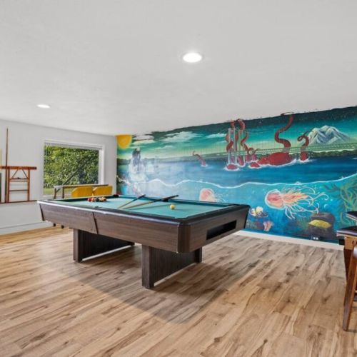 Large game room on the lower level with local artist's mural of Narrows Bridge PNW sealife