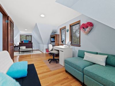 Escape into a cozy retreat with this charming loft twin "nest" bedroom. The unique design and thoughtful layout includes an office desk, chair, games, boks, and a small sofa.