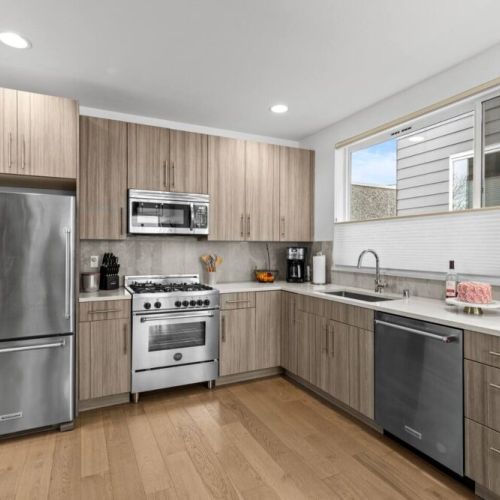 The brightly lit Kitchen has stainless steel applicances with a 4-burner gas range