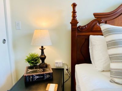 This queen bedroom has a multiple option charging station at each night stand and a white noise machine. zZzz