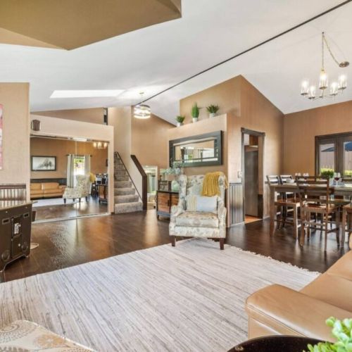 Unwind and engage in friendly competition in the inviting sitting area of the game room, surrounded by a collection of board games and an arcade machine.