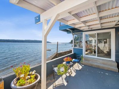 The covered patio is perfect for alfresco dinners, sipping your morning coffee while listening to the soothing sounds of nature, or simply lounging with a good book on a lazy Sunday afternoon.