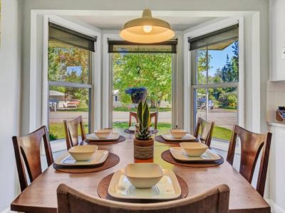 The beauty of our natural light dining area, where sunshine pours in through large windows, illuminating the space with a warm and inviting glow.