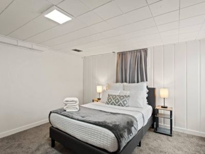 This charming lower level cottage-style bedroom  is tucked away off of the laundry/game room. It includes an office desk and chair, extra pillows and blankets.