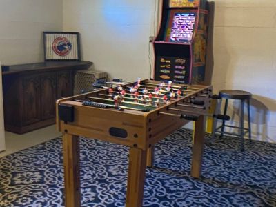 The game room includes foosball table, axe & dart throwing game, and a Mrs Pac-Man arcade  with 12 games.