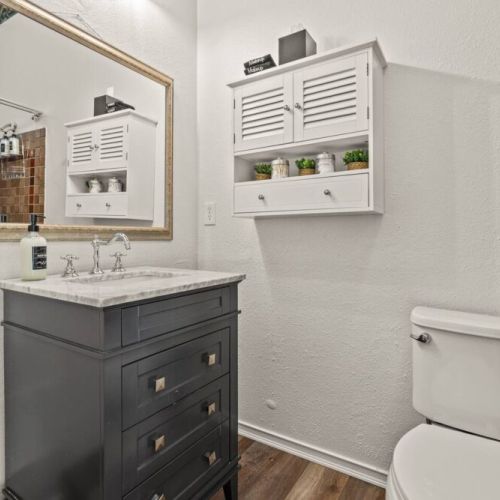 Main Floor Full Bathroom with a tub-shower is located across the hall from the two queen bedrooms